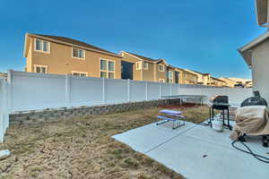 View of yard featuring a fenced backyard, a trampoline, a residential view, and a patio