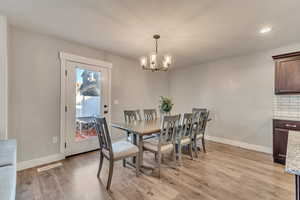 Dining room featuring baseboards, visible vents, an inviting chandelier, light wood-style floors, and recessed lighting