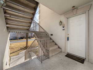 Property entrance featuring stucco siding