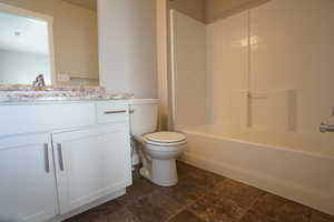 Full bath with shower / bathtub combination, vanity, and toilet