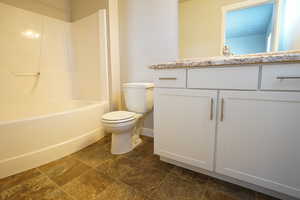 Full bathroom featuring vanity, toilet, and baseboards