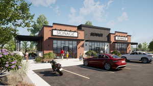 View of building exterior featuring uncovered parking