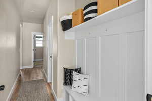 Mudroom with baseboards and wood finished floors