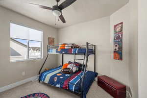 Bedroom featuring carpet floors, ceiling fan, and baseboards