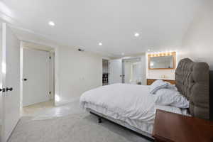 Bedroom featuring light carpet, light tile patterned floors, visible vents, and recessed lighting