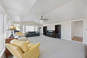 Living room featuring baseboards, lofted ceiling, ceiling fan, carpet, and recessed lighting