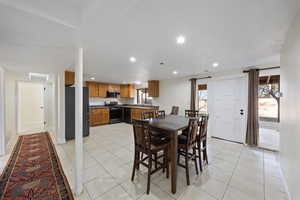 Dining space with recessed lighting and light tile patterned floors