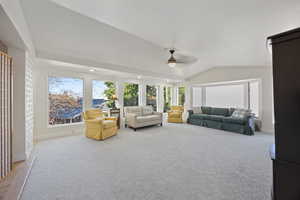 Living area featuring recessed lighting, light carpet, vaulted ceiling, and ceiling fan