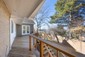 Deck featuring a fenced backyard and french doors