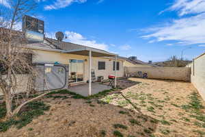 Rear view of property with a patio area, a fenced backyard, and stucco siding