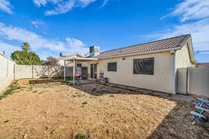 Back of house with a patio, a fenced backyard, a tile roof, and stucco siding