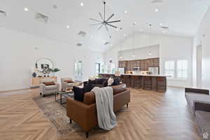 Living room featuring recessed lighting, baseboards, visible vents, and high vaulted ceiling