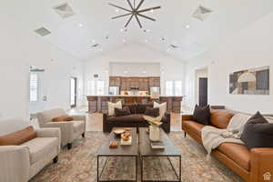 Living room featuring visible vents and high vaulted ceiling