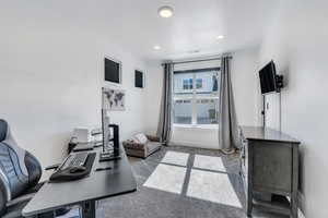 Office area featuring carpet, baseboards, and recessed lighting