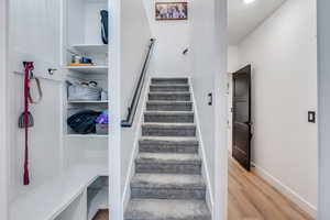 Stairs featuring baseboards and wood finished floors