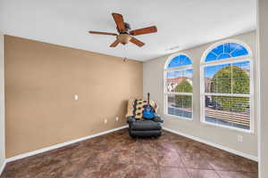 Unfurnished room featuring ceiling fan, visible vents, and baseboards