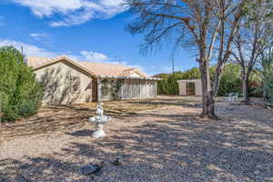 Exterior space with a tile roof and stucco siding