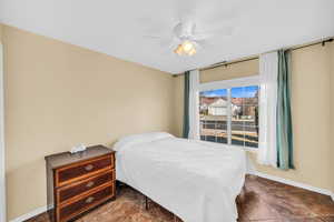 Bedroom with ceiling fan and baseboards