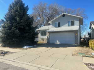 View of front of property with a garage and concrete driveway