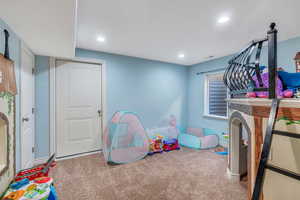 Rec room with carpet, visible vents, baseboards, and recessed lighting