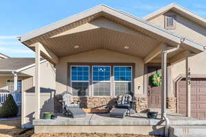 Property entrance with stone siding and stucco siding