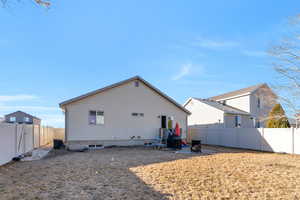 Rear view of house featuring a fenced backyard