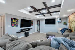 Living room with carpet floors, baseboards, coffered ceiling, and recessed lighting