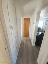 Hallway featuring baseboards and wood finished floors