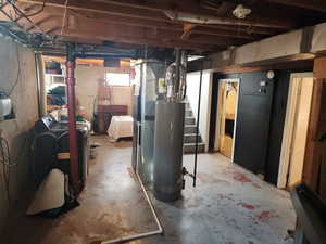 Basement with stairs and water heater