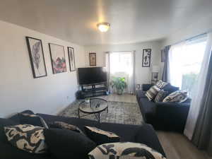 Living area with baseboards and wood finished floors