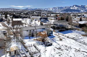 Snowy aerial view with a residential view and a mountain view