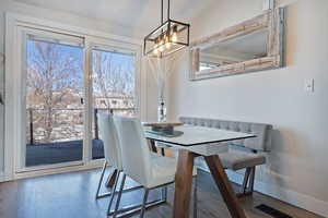 Dining space featuring wood finished floors, visible vents, and baseboards