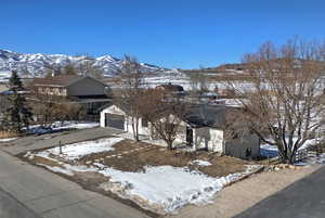 View of front of house with driveway and a mountain view