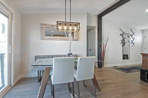 Dining area with wood finished floors and baseboards