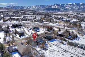 Snowy aerial view with a residential view and a mountain view