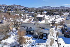 Snowy aerial view with a residential view and a mountain view