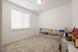 Rec room featuring carpet flooring and baseboards