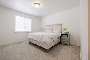 Bedroom with carpet and baseboards