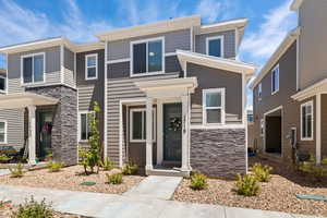 View of front facade featuring stone siding