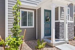 View of exterior entry featuring stone siding