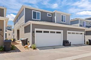 View of property with driveway and an attached garage