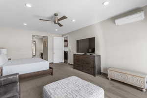 Bedroom with recessed lighting, baseboards, a wall unit AC, and carpet flooring