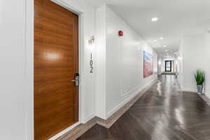 Entry corridor featuring baseboards and recessed lighting