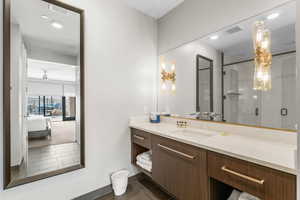 Bathroom with visible vents, connected bathroom, tile patterned flooring, vanity, and a shower stall