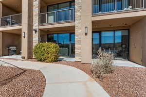 Doorway to property with stone siding and stucco siding