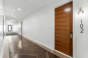 Entry corridor featuring recessed lighting and a decorative wall