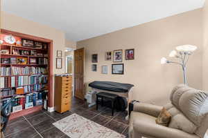 Bedroom with dark tile patterned floors and a textured ceiling