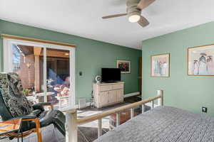 Tiled bedroom featuring access to outside, baseboards, and a ceiling fan