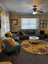 Living area with ceiling fan, ornamental molding, carpet flooring, and recessed lighting