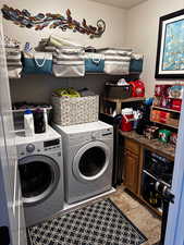 Laundry room featuring washer and clothes dryer